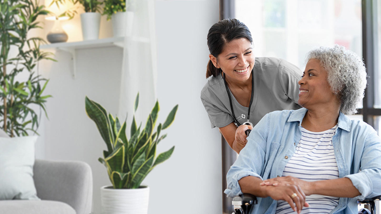 a woman smiling while sitting in a wheelchair
