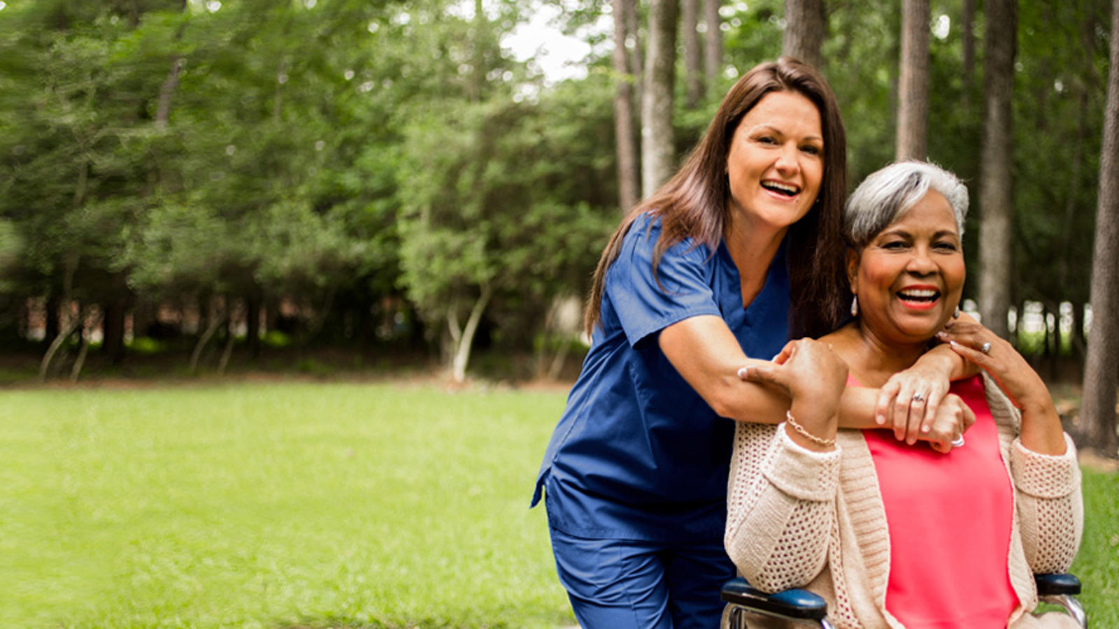 a woman in a wheelchair with a nurse