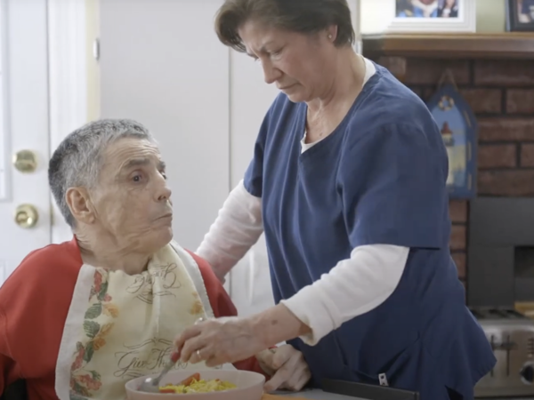 a woman feeding a man