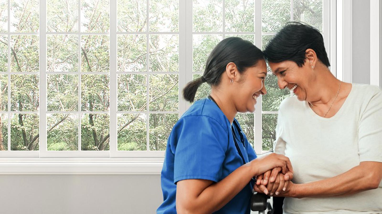 a nurse holding a woman's hand