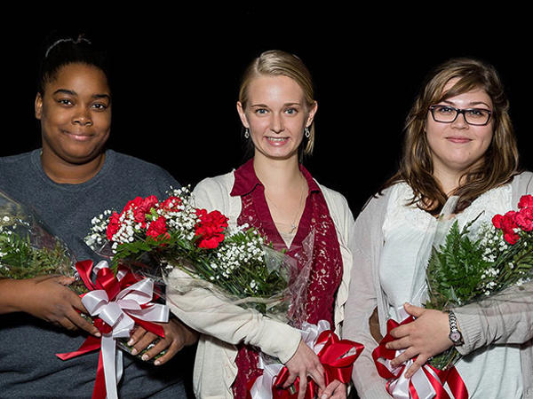 a group of women holding flowers