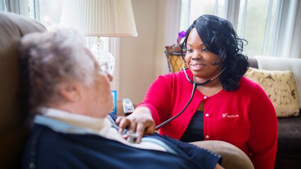 a woman using a stethoscope to listen to a man