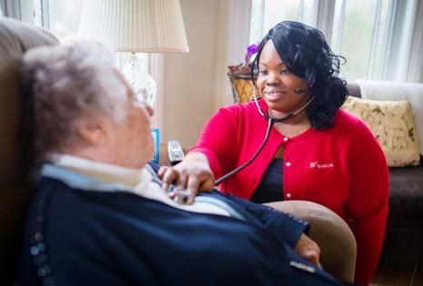 a woman using a stethoscope to listen to a man