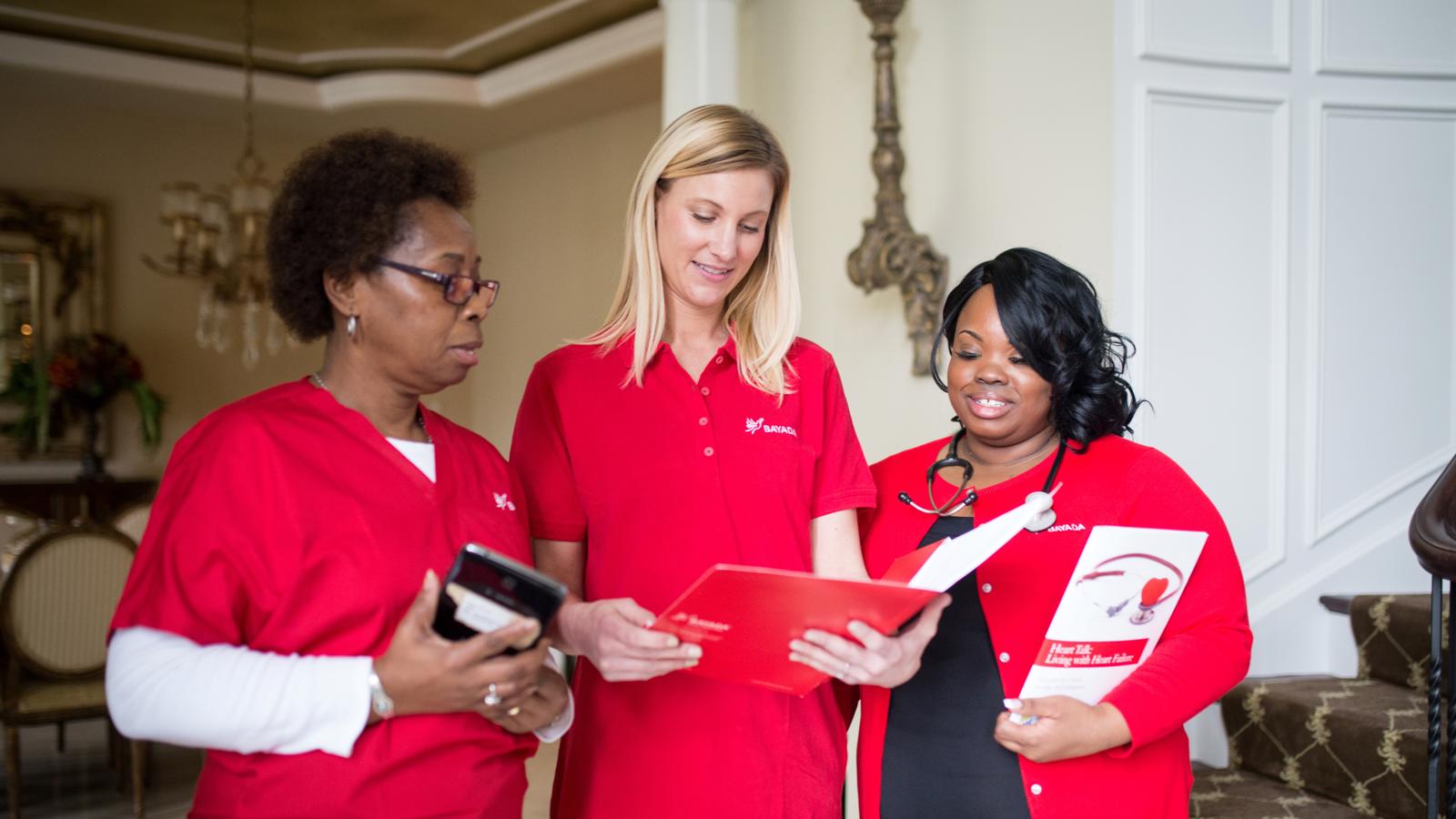 a group of women in red shirts