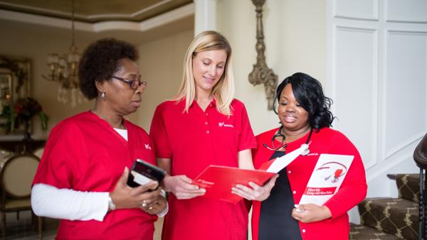 a group of women in red shirts