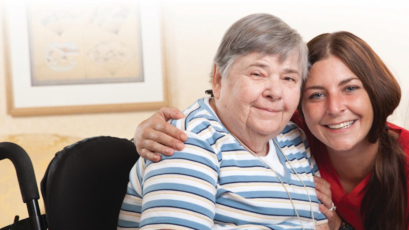 a woman in a wheelchair with a nurse