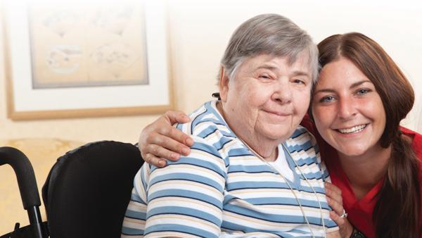 a woman in a wheelchair with a nurse
