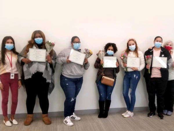 a group of people holding certificates