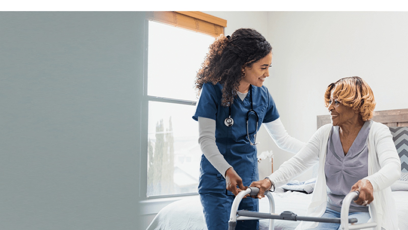 a nurse pushing a walker with a patient