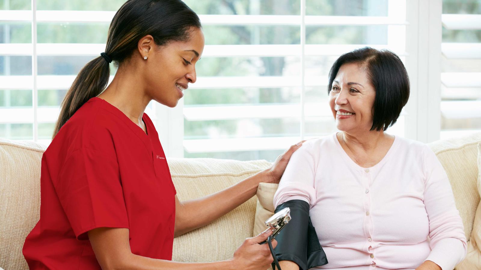 a nurse taking a blood pressure of a woman
