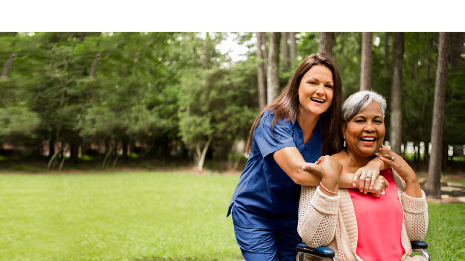 a woman in a wheelchair with a nurse on her shoulder