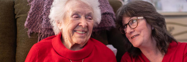 two women sitting on a couch