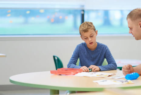 a boy sitting at a table