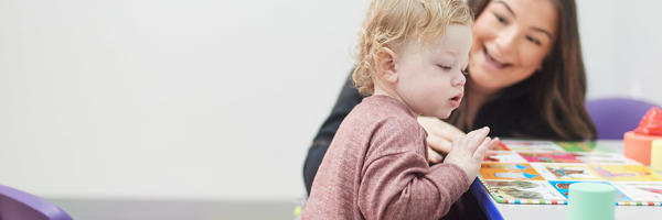 a woman and baby playing with a game