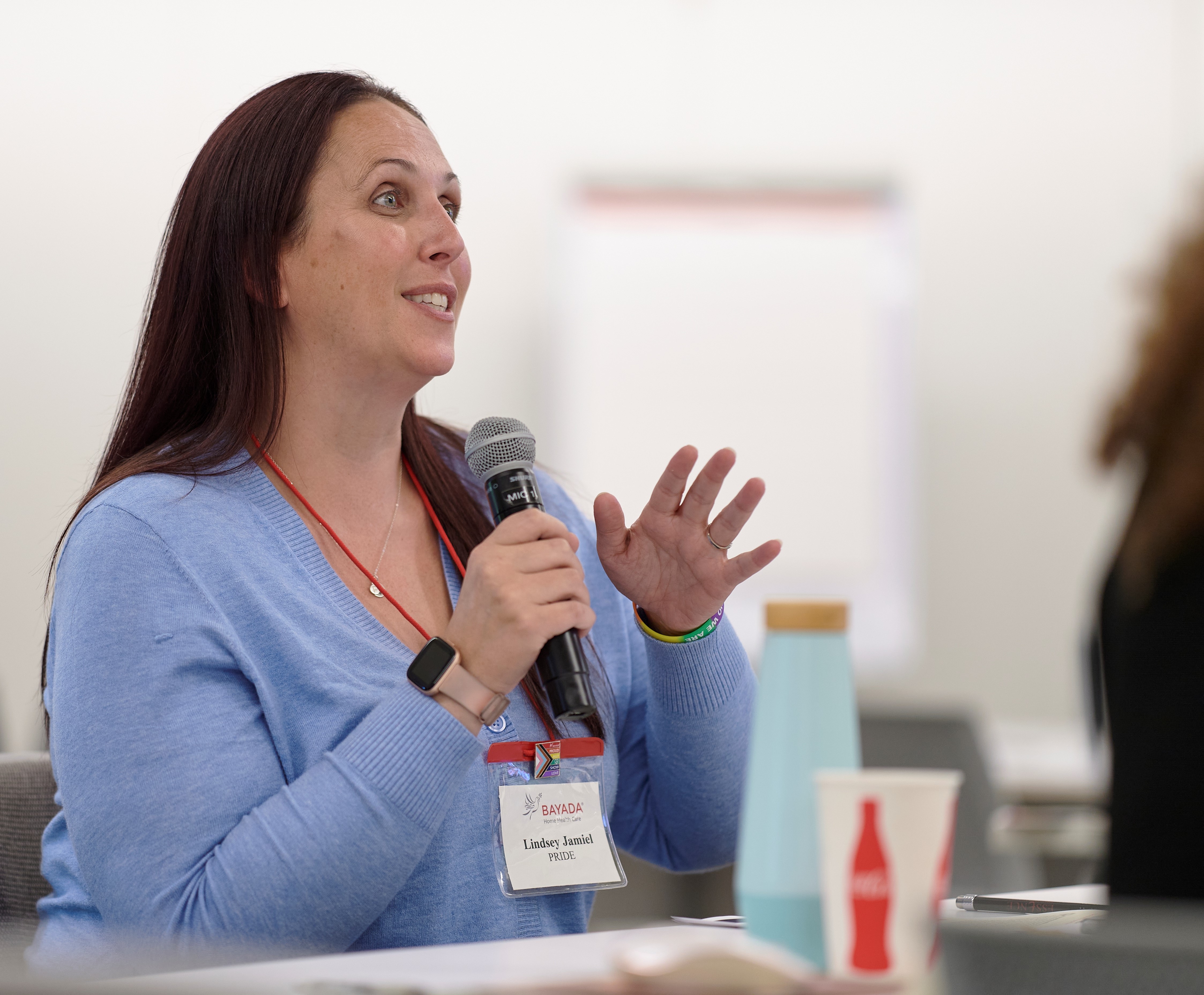 a woman speaking into a microphone