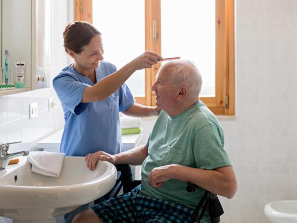 Stock Nurse Grooming Patient