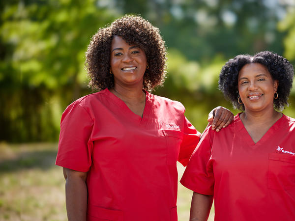 a group of women wearing red scrubs