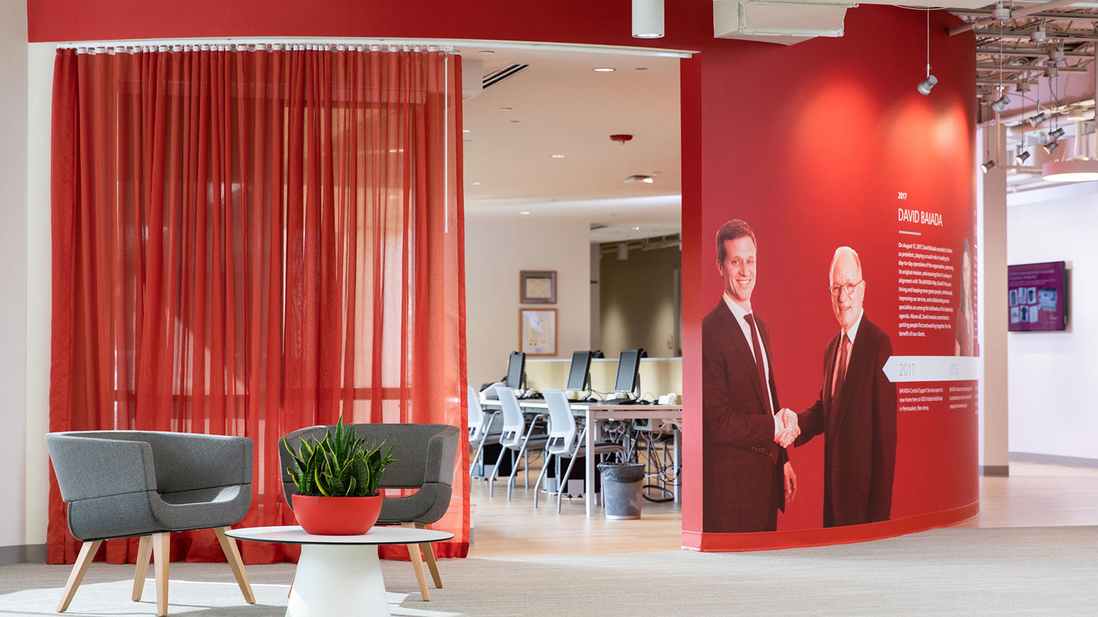 a red wall with a picture of two men on it