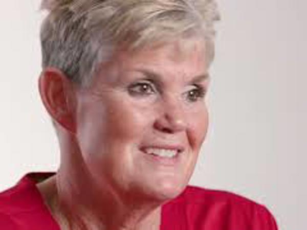 a woman with short hair wearing a red shirt