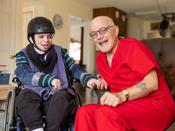a man in a wheelchair and a woman in a helmet