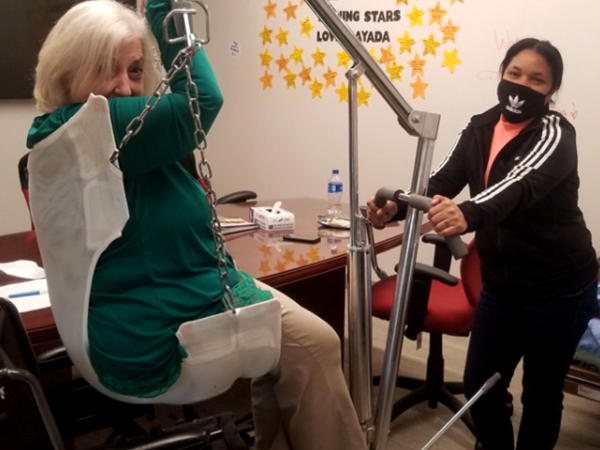 a woman in a chair with a chain attached to a woman in a room