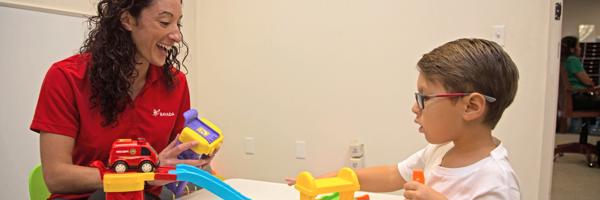 a woman and a boy playing with toys