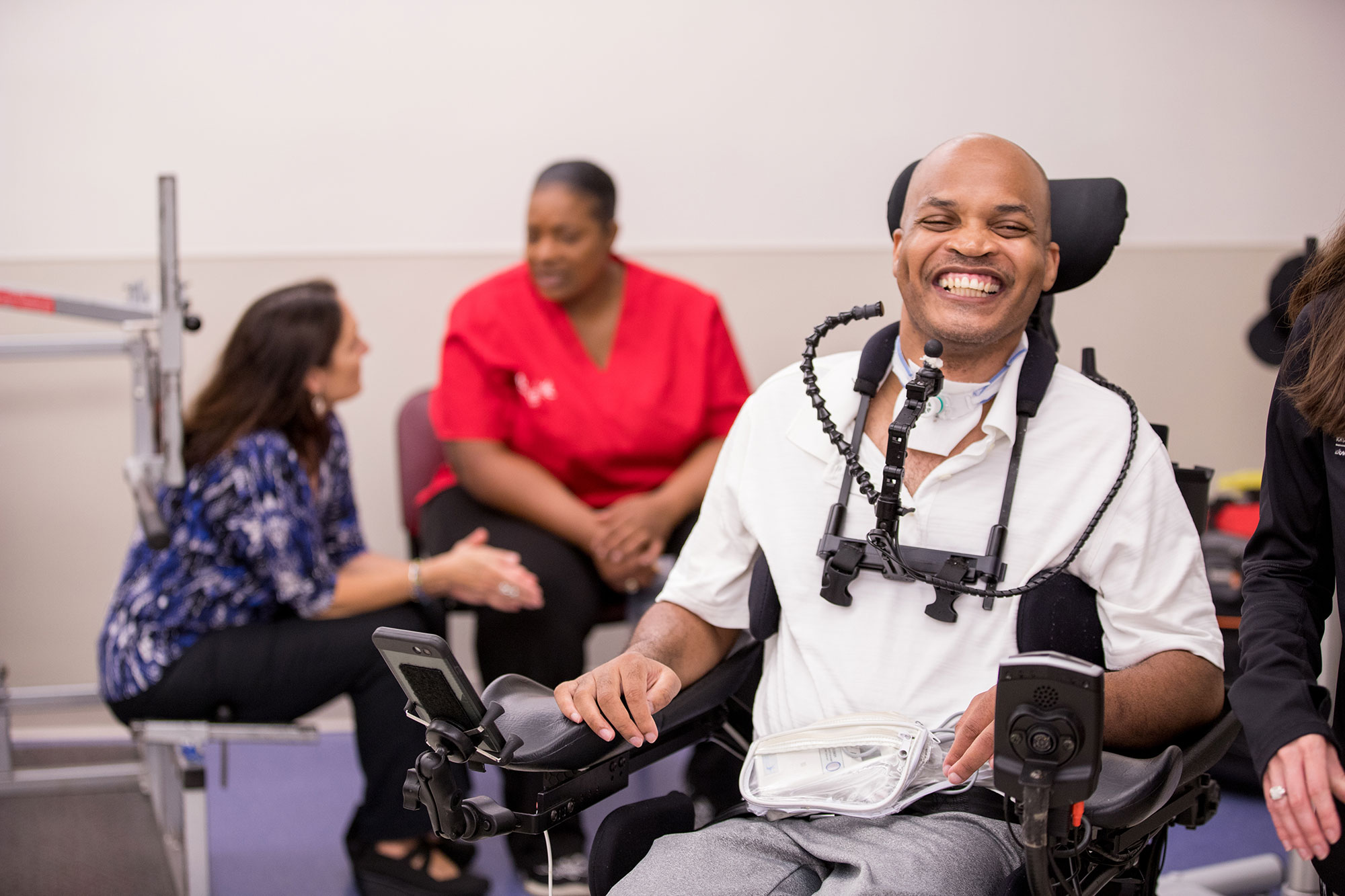 a man in a wheelchair smiling