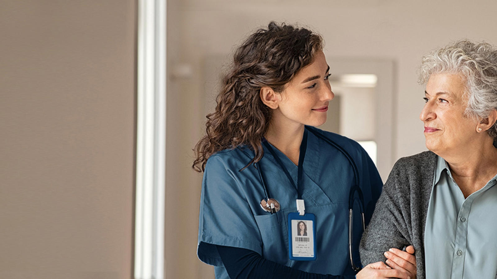 a woman in blue scrubs holding a baby